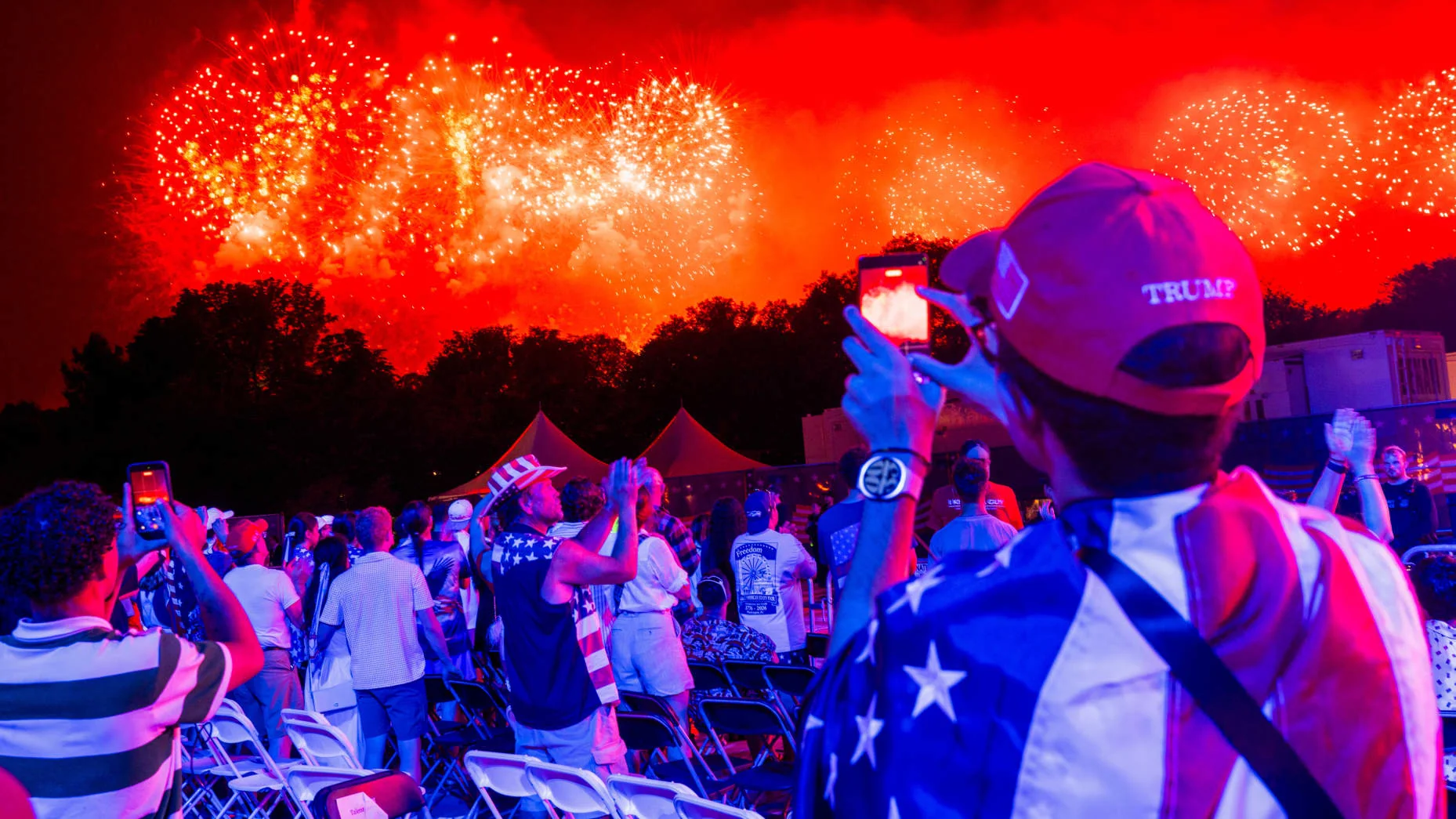 Attendees watch a fireworks display during the "Salute to America" event on the National Mall in Washington, DC, US, early on Sunday, July 5, 2026. Attendees at Washington